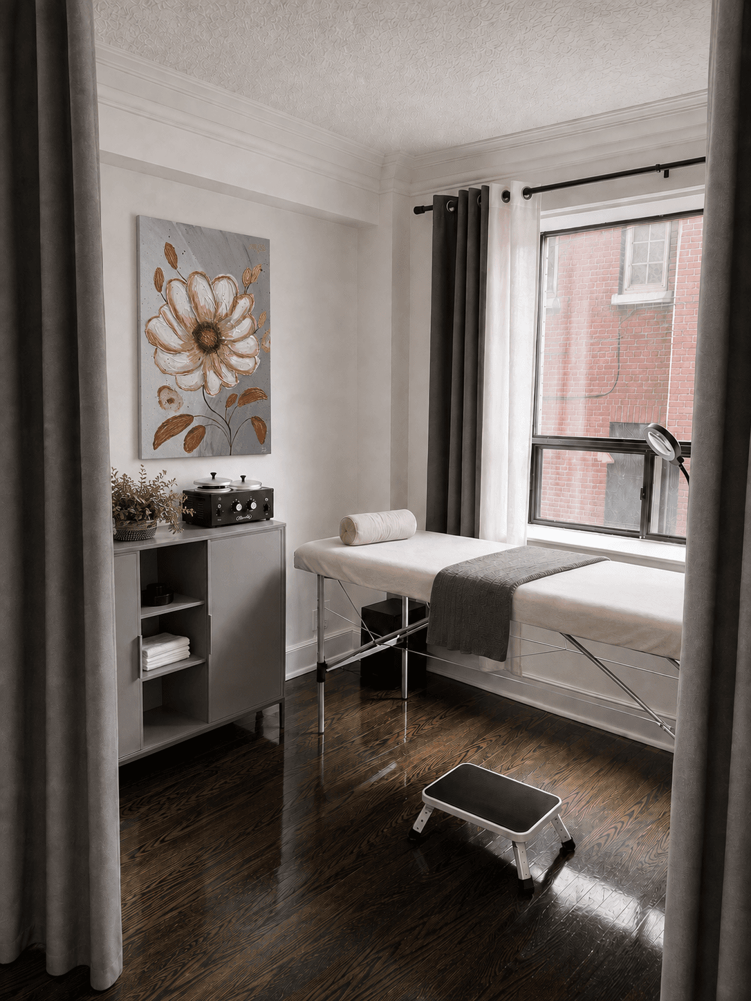 View through the curtained doorway into a VYRO treatment room, with a floral painting above the supply cabinet